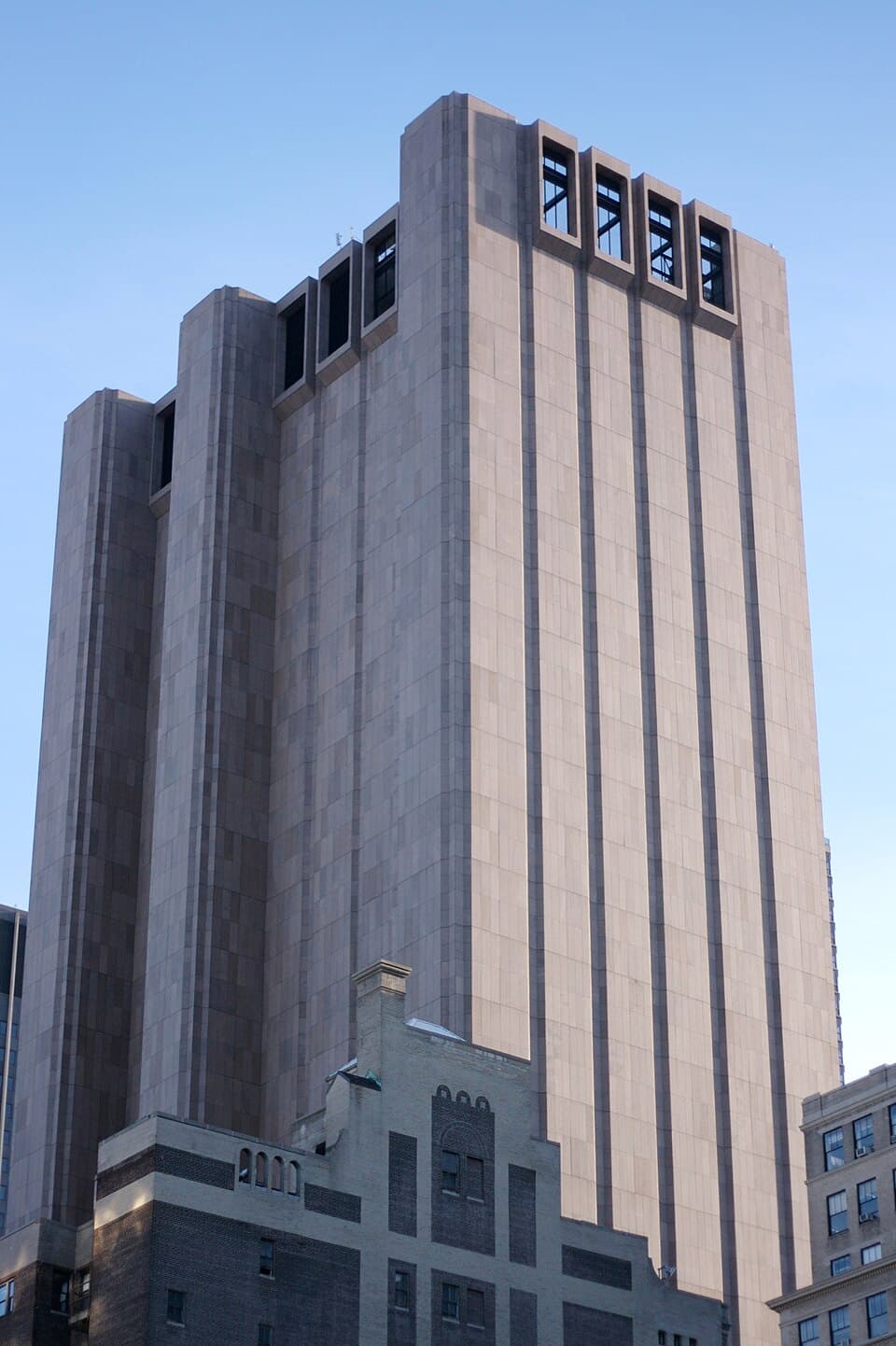 A detailed pencil sketch comparing the imposing, windowless concrete facade of the 33 Thomas Street Brutalist skyscraper in Manhattan with the Victorian brick structure of Georgia Tech's Tech Tower, rendered with architectural precision. No text, no logos.