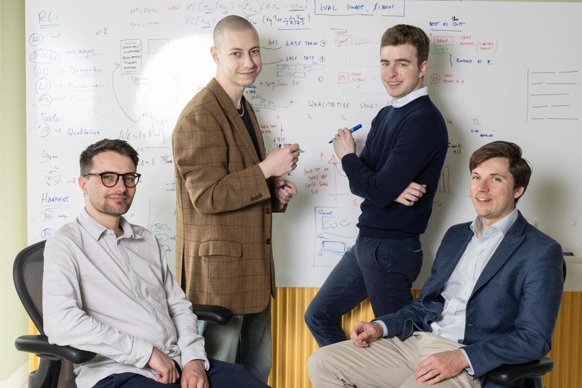 A watercolor illustration of a sleek laboratory bench holding a vintage scientific notebook, a beaker, and a small glowing AI core labeled “Faraday” beside an open research paper, set against a backdrop of London’s King’s Cross architecture; no text, no logos.